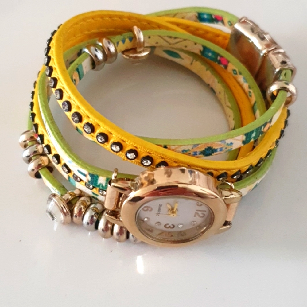 Yellow designer fashionable Watch on the bundle of bracelets